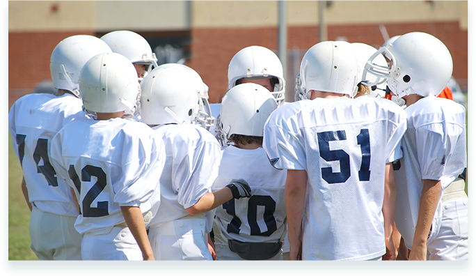 Group of kids with there football uniform in a circle
